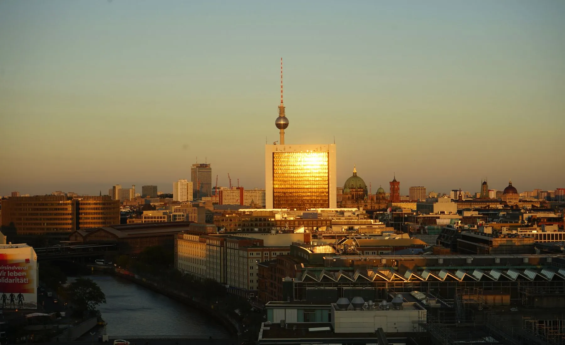 The Berlin skyline at dusk, with the Fernsehturm and the Berliner Dom above the Spree